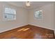 Light-filled bedroom featuring hardwood floors and two windows that provide natural light at 5300 Buckingham Dr, Charlotte, NC 28209