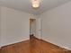 Bright bedroom featuring hardwood floors, neutral walls, and modern ceiling light at 5300 Buckingham Dr, Charlotte, NC 28209
