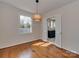 Bright dining room with hardwood floors, modern lighting, and access to the kitchen through double doors at 5300 Buckingham Dr, Charlotte, NC 28209