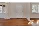Inviting entryway showcasing gleaming hardwood floors, a bright window, and a solid white door at 5300 Buckingham Dr, Charlotte, NC 28209