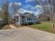 Single-story home with a welcoming screened-in porch and a driveway, perfect for easy parking at 5300 Buckingham Dr, Charlotte, NC 28209