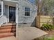 Charming front entrance with brick steps and gray exterior siding at 5300 Buckingham Dr, Charlotte, NC 28209