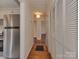 Hallway featuring hardwood floors, closet space, access to the kitchen and multiple doorways at 5300 Buckingham Dr, Charlotte, NC 28209