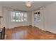 Well-lit living room boasting large windows, hardwood floors, and elegant white curtains at 5300 Buckingham Dr, Charlotte, NC 28209