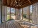 Relaxing screened porch with wooden floor, ceiling fan, and outdoor views at 5300 Buckingham Dr, Charlotte, NC 28209