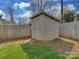 Close up of a white wooden shed in a fenced in backyard at 5300 Buckingham Dr, Charlotte, NC 28209