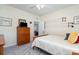 Comfortable bedroom featuring a wooden dresser and rods for hanging items, providing practical storage solutions at 6187 Cloverdale Dr, Tega Cay, SC 29708