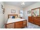 Cozy bedroom with a ceiling fan, complemented by a wooden bed frame and matching dresser set for ample storage at 6187 Cloverdale Dr, Tega Cay, SC 29708
