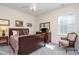 Cozy bedroom with a bed, dresser, and chair, creating a relaxing retreat at 6187 Cloverdale Dr, Tega Cay, SC 29708
