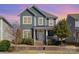 Charming two-story home featuring a welcoming front porch, well-maintained landscaping, and a beautiful gray facade at 6187 Cloverdale Dr, Tega Cay, SC 29708