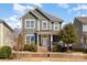 Charming two-story home featuring a welcoming front porch, well-maintained landscaping, and a beautiful gray facade at 6187 Cloverdale Dr, Tega Cay, SC 29708