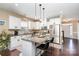 Bright kitchen features granite counters, stainless steel appliances and island with seating and a view of the front door at 6187 Cloverdale Dr, Tega Cay, SC 29708