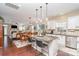 Well-lit kitchen has granite counters, stainless appliances and an island with bar seating that opens to the living and dining areas at 6187 Cloverdale Dr, Tega Cay, SC 29708