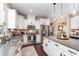 Kitchen with stainless appliances, granite countertops, and island with seating, creates an inviting cooking and gathering space at 6187 Cloverdale Dr, Tega Cay, SC 29708