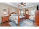 Spacious main bedroom featuring a four-poster bed, tray ceiling, and abundant natural light creates a serene and relaxing atmosphere at 6187 Cloverdale Dr, Tega Cay, SC 29708