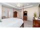 Spacious primary bedroom featuring a tray ceiling, 4-poster bed, and access to the ensuite bathroom at 6187 Cloverdale Dr, Tega Cay, SC 29708