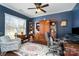 This office features a large window, built-in shelving, crown molding and a ceiling fan for a comfortable workspace at 6187 Cloverdale Dr, Tega Cay, SC 29708