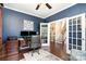 Office with french doors leading to the stairs, detailed trim work, and built in shelves provides a private workspace at 6187 Cloverdale Dr, Tega Cay, SC 29708