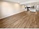 Expansive basement with modern flooring and an open layout, leading to the kitchen at 6436 Old Pineville Rd # C, Charlotte, NC 28217