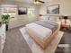 Bright bedroom with a platform bed, soft white bedding, neutral walls, and two sunny windows at 6436 Old Pineville Rd # C, Charlotte, NC 28217