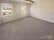 Clean, carpeted bedroom with two windows and a ceiling fan at 6436 Old Pineville Rd # C, Charlotte, NC 28217