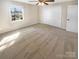 Bedroom with neutral carpet, a ceiling fan, large window, and a closet with double doors at 6436 Old Pineville Rd # C, Charlotte, NC 28217