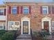 Charming brick townhome exterior featuring classic red shutters and well-maintained landscaping at 6436 Old Pineville Rd # C, Charlotte, NC 28217
