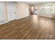 Spacious living room with wood floors, a large window, and a freshly painted neutral color scheme at 6436 Old Pineville Rd # C, Charlotte, NC 28217