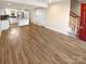 Open living space featuring a modern kitchen, new flooring, and a staircase at 6436 Old Pineville Rd # C, Charlotte, NC 28217