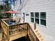 An inviting back deck features a dark wood stain, stairs to yard, an umbrella, and outdoor seating at 734 Rocky Grove Gln, York, SC 29745