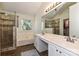 This bathroom features a separate shower, soaking tub, and dual sink vanity at 7402 Henderson Park Rd, Huntersville, NC 28078