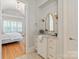 Bathroom featuring a vanity with marble countertop, gold accents and access to bedroom at 7924 Pemswood St, Charlotte, NC 28277