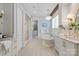 Luxurious bathroom featuring a soaking tub, glass shower, double vanity, and a view into the closet at 7924 Pemswood St, Charlotte, NC 28277