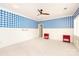Large bedroom features bright blue and white checkerboard wallpaper at 7924 Pemswood St, Charlotte, NC 28277