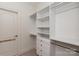 Walk-in closet has white shelving units and rods for organizing clothes at 7924 Pemswood St, Charlotte, NC 28277
