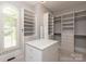 Spacious walk-in closet with custom shelving, ample storage space, and a central island at 7924 Pemswood St, Charlotte, NC 28277