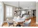 Inviting dining area featuring hardwood floors and abundant natural light from the large windows at 7924 Pemswood St, Charlotte, NC 28277
