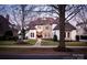 Elegant home featuring a stone and stucco facade, manicured lawn, and professional landscaping at 7924 Pemswood St, Charlotte, NC 28277