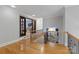 Spacious hallway with hardwood floors, leading to an open doorway and staircase at 7924 Pemswood St, Charlotte, NC 28277