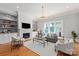 Bright living room features fireplace, custom built-ins, hardwood floors and a modern chandelier at 7924 Pemswood St, Charlotte, NC 28277