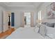 Bright bedroom with stylish wallpaper, hardwood floors, and easy access to the bathroom and closet at 7924 Pemswood St, Charlotte, NC 28277