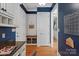 View of a mudroom area with blue accents, built-in shelving, and a bench with baskets at 7924 Pemswood St, Charlotte, NC 28277