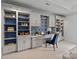 Home office with built-in shelving, desk space, and stylish blue accents at 7924 Pemswood St, Charlotte, NC 28277