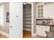 Walk-in pantry with shelving for maximum storage, complemented by nearby white cabinets at 7924 Pemswood St, Charlotte, NC 28277