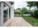 Stone patio features well manicured lawn area and iron fencing offering style and security at 7924 Pemswood St, Charlotte, NC 28277