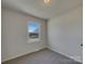 Bright bedroom with neutral tones, large window and carpeted floor at 8103 Idlewild Rd, Indian Trail, NC 28079