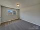Cozy bedroom with neutral tones and large window, carpeted and bright at 8103 Idlewild Rd, Indian Trail, NC 28079