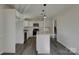 Eat-in kitchen with island, updated lighting, stainless steel appliances, and white cabinets at 8103 Idlewild Rd, Indian Trail, NC 28079