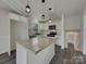 Modern kitchen features stone countertops, island and stainless steel appliances at 8103 Idlewild Rd, Indian Trail, NC 28079