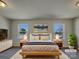 Staged main bedroom featuring soft lighting, two windows, and neutral decor at 8103 Idlewild Rd, Indian Trail, NC 28079